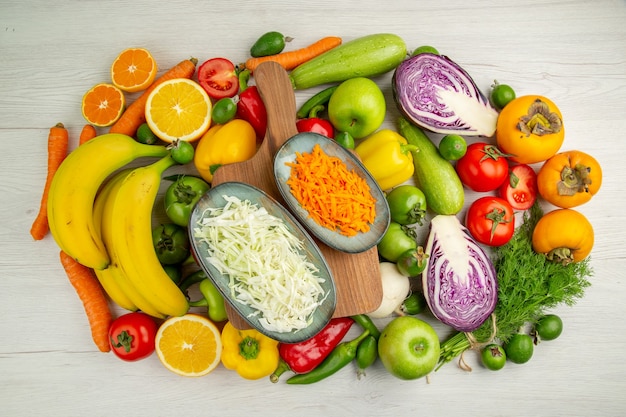 Top view vegetable composition with fruits on a white background