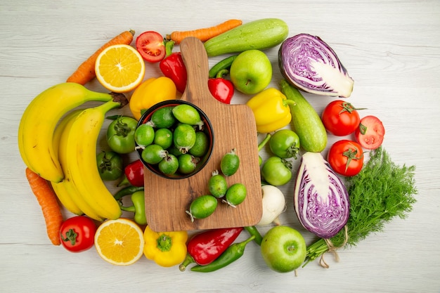 Top view vegetable composition with fruits on the white background