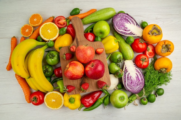 Top view vegetable composition with fruits on the white background