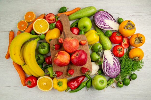 Top view vegetable composition with fruits on the white background