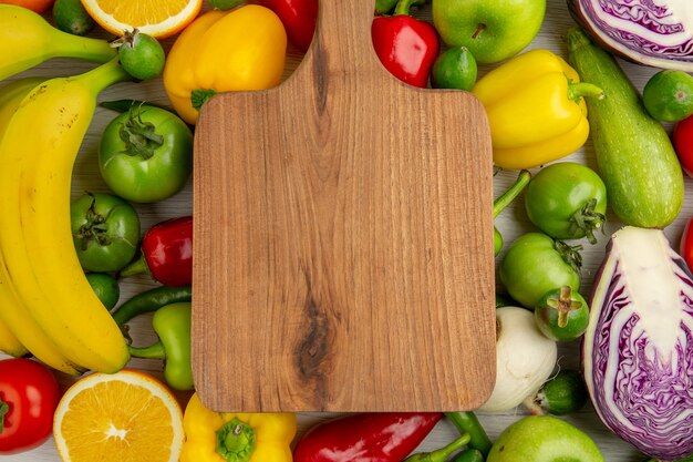 Top view vegetable composition with fruits on white background