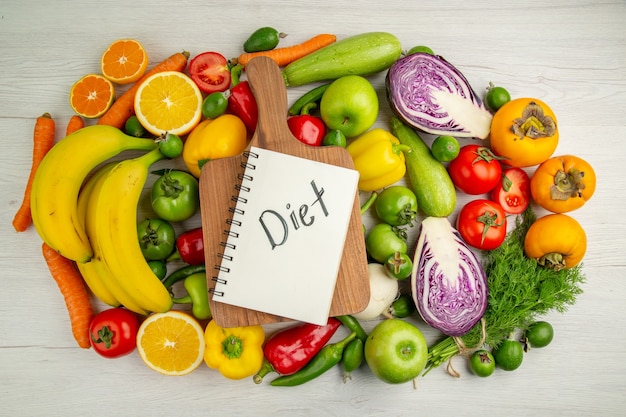 Free photo top view vegetable composition with fruits on white background