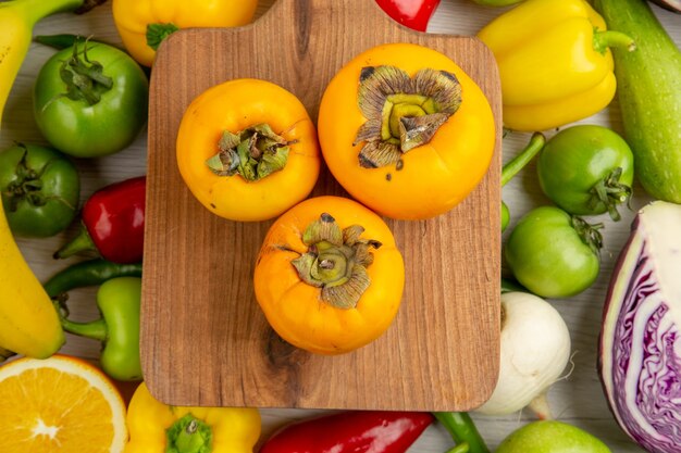 Top view vegetable composition with fruits on white desk