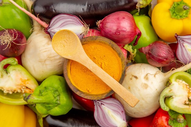 Top view vegetable composition with seasonings on a white table