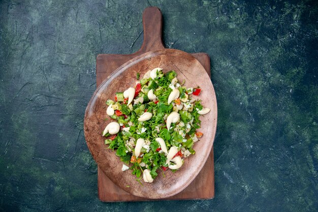 top view vegetable salad inside elegant plate on dark blue background cuisine color kitchen lunch health fit meal dinner diet