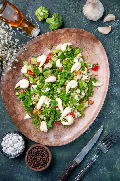 top view vegetable salad inside elegant plate with cutlery on dark blue background lunch health restaurant cuisine meal color