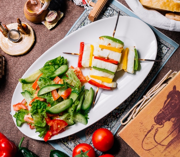 Top view vegetable salad with cheese and bell pepper on sticks