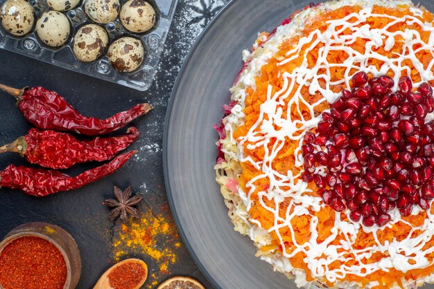 Top view vegetable salad with pomegranates and different ingredients on the dark background color meal photo salad new year lunch snack holiday