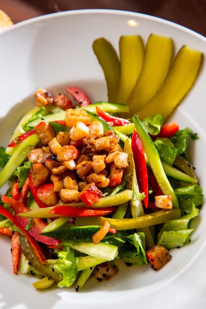 Top view vegetable salad with salted cucumbers
