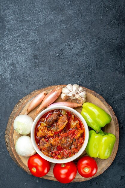 Top view vegetable soup with fresh vegetables on the grey