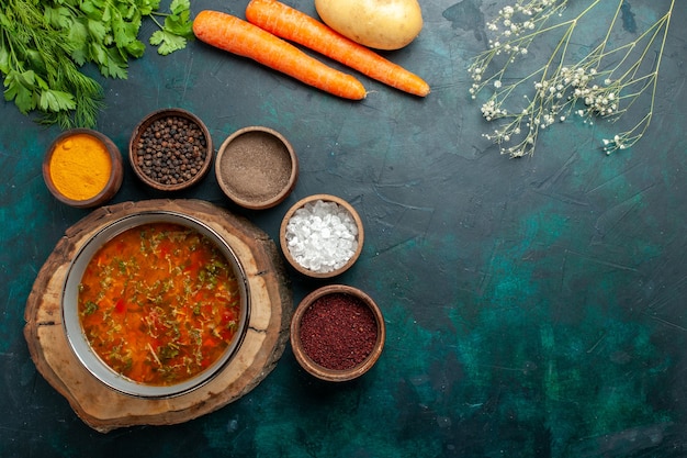 Top view vegetable soup with seasonings on dark-green background ingredient soup meal food vegetable