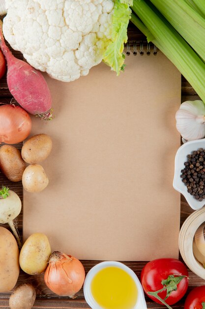 Top view of vegetables as cauliflower radish tomato celery and others with butter and black pepper with copy space