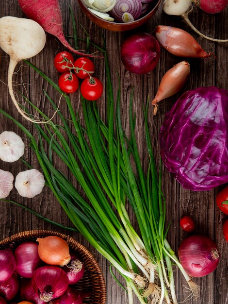 Top view of vegetables as onion radish garlic cabbage on wooden background