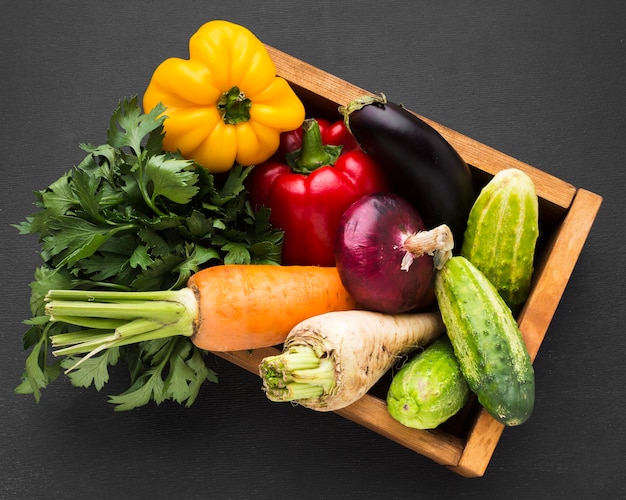 Top view vegetables assortment on dark background