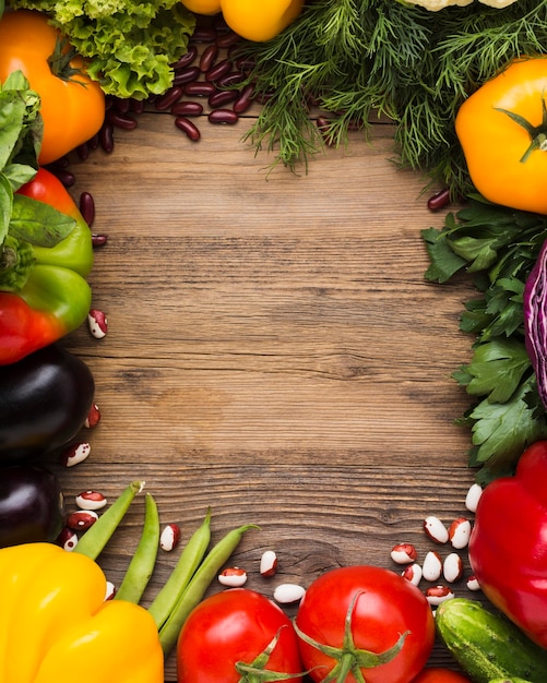 Top view vegetables assortment with copy space on wooden background