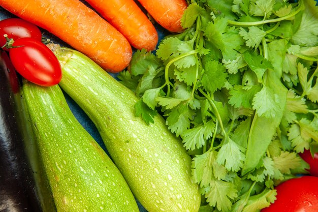 Top view vegetables carrot zucchini cherry tomatoes parsley aubergines