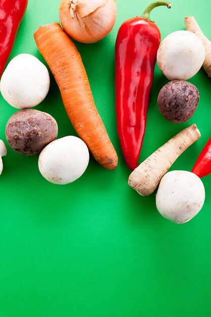 Top view of vegetables on green background in studio photo