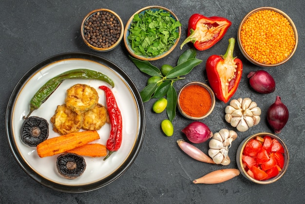 Top view of vegetables herbs lentil vegetables spices citrus fruits dish of mushrooms pepper