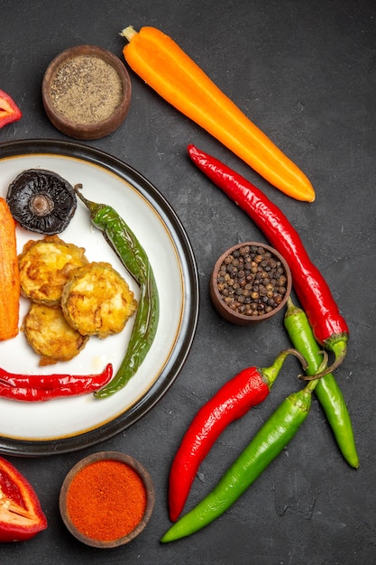 Top view of vegetables hot peppers colorful spices carrots roasted vegetables