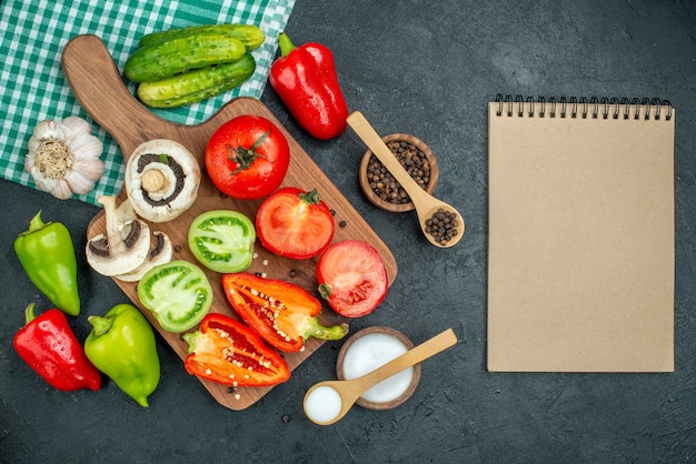 Top view vegetables mushrooms tomatoes red bell peppers on cutting board