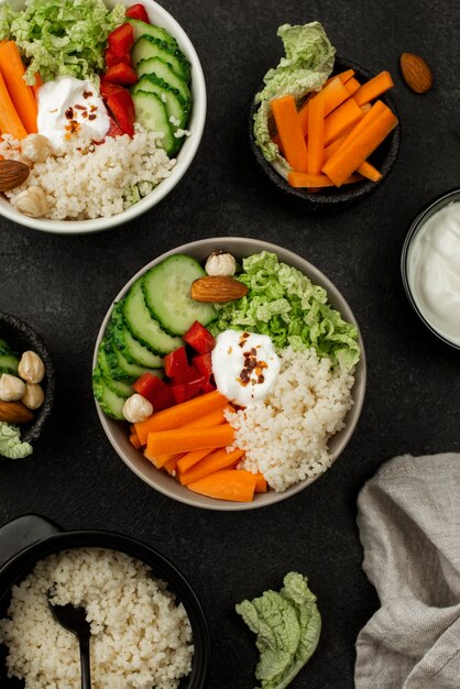 Top view veggie salad bowls with couscous and carrots
