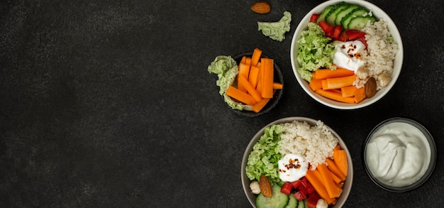 Top view veggie salad bowls with couscous and copy-space