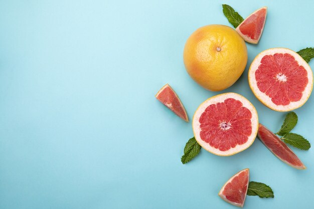 Top view vertical shot of strawberries on a blue and pink