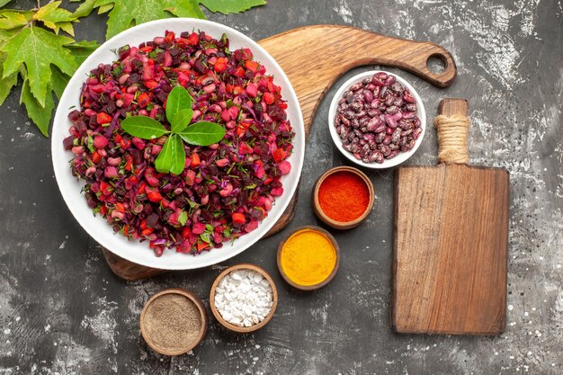 Top view vinaigrette salad with beet and beans on the grey surface