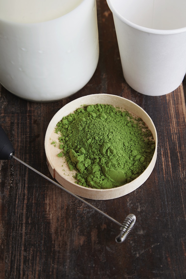 Free Photo top view vintage milk bottle, electric milk frother, white paper take away glass and organic premium matcha tea powder on brown brushed wooden table