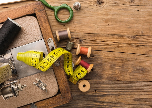 Top view of vintage sewing machine with thread and measuring tape