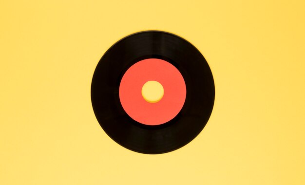 Top view vinyl disc on yellow background