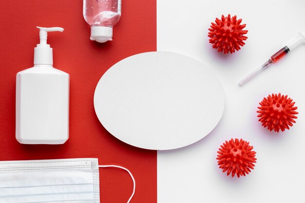 Top view of viruses with syringe and liquid soap bottle