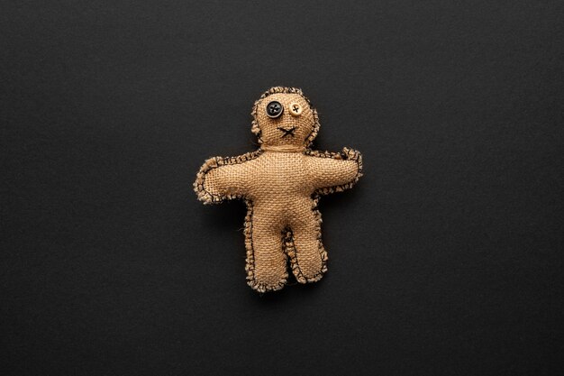 Top view voodoo doll on dark background