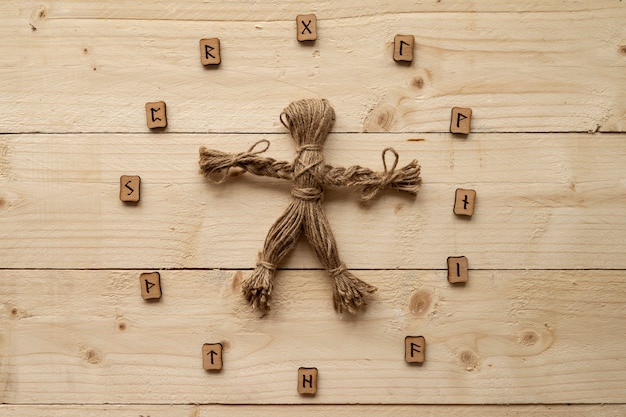 Free photo top view voodoo doll on wooden background