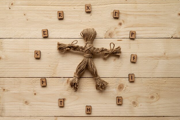 Top view voodoo doll on wooden background