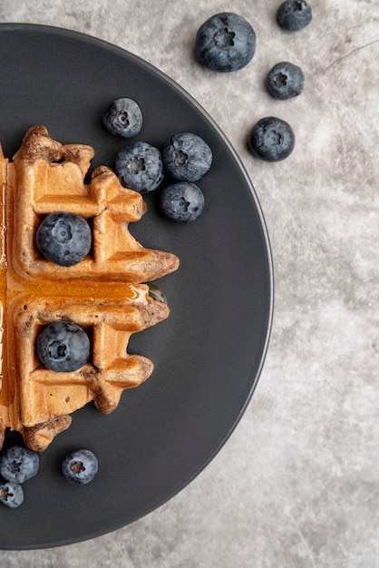 Free photo top view of waffle on plate with blueberries