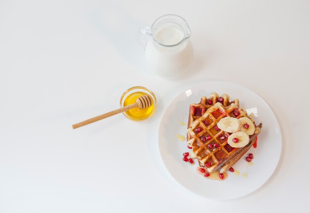 Top view waffle with honey and milk