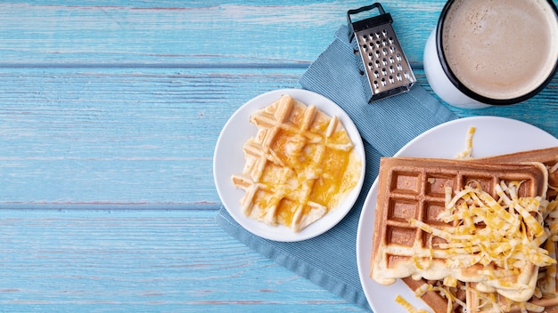 Top view of waffles on plate with grated cheese