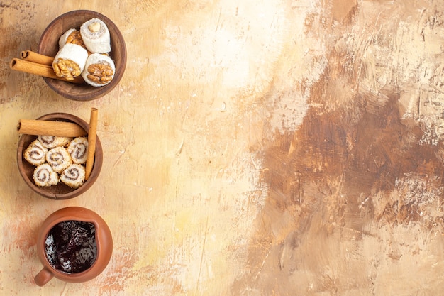 Top view walnut confitures with cinnamon on wooden desk