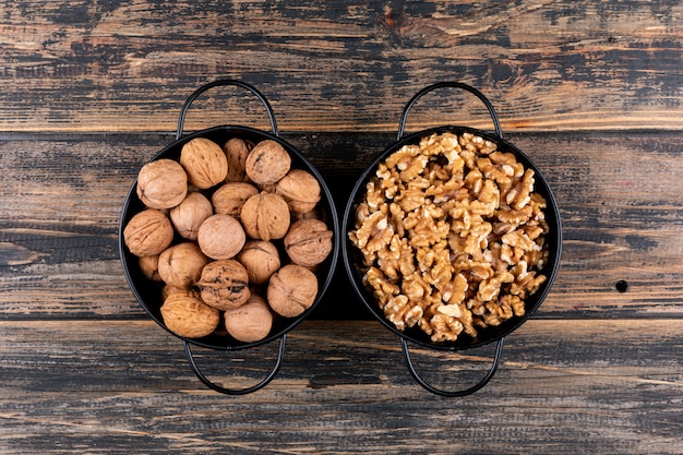 Top view walnuts in baskets on wooden  horizontal