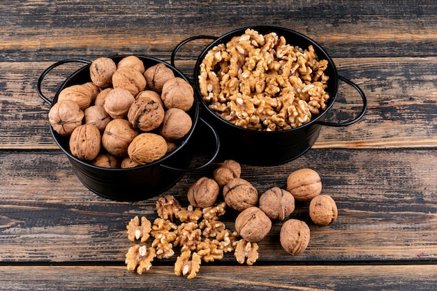 Top view walnuts in baskets on wooden  horizontal