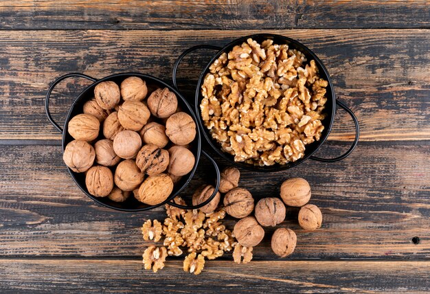 Top view walnuts in baskets on wooden  horizontal