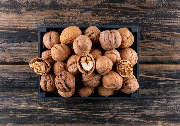 Top view walnuts in black box on wooden  horizontal