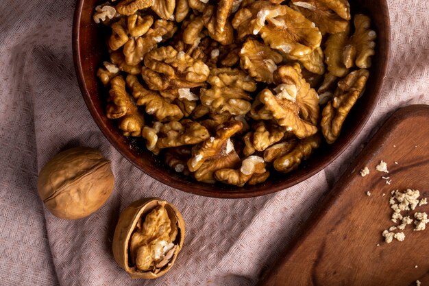 Top view of walnuts in a bowl on a tablecloth