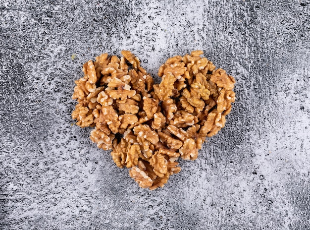 Top view walnuts heart shaped on stone  horizontal