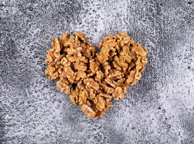 Top view walnuts heart shaped on stone  horizontal