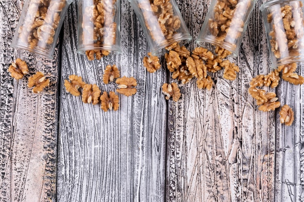 Top view walnuts in jars with copy space on wooden  horizontal