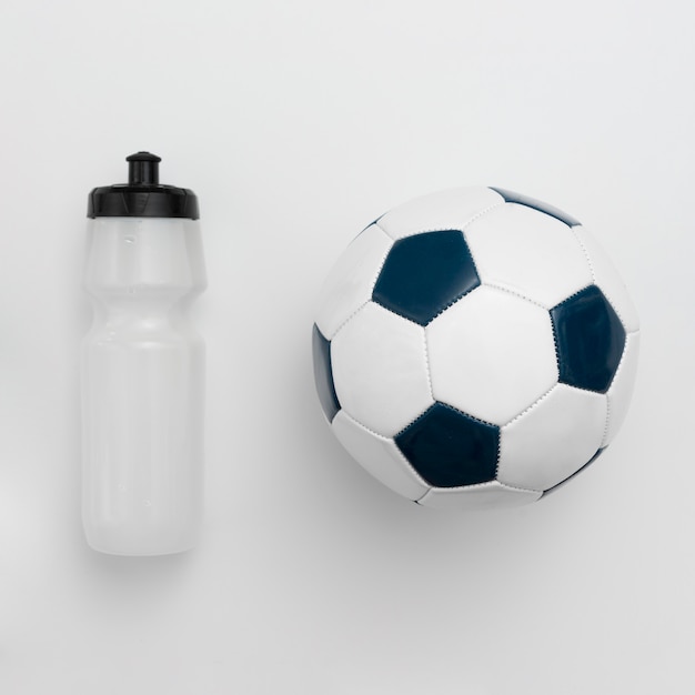 Free photo top view of water bottle with football