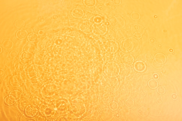 Free photo top view water texture on orange