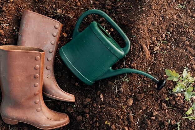 Top view of watering can and boots 